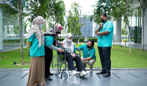 Illustration of a young man and woman helping an elderly couple